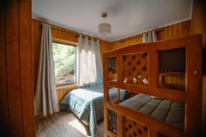 a bedroom with a bunk bed and a window at Nevisca 5p in Curacautín