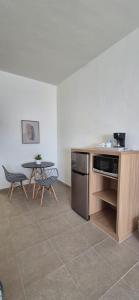 a kitchen with a table and a table and chairs at Suites EL FARO San Carlos in San Carlos