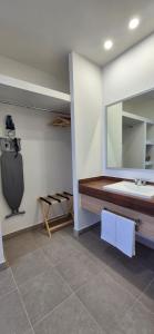a bathroom with a sink and a mirror at Suites EL FARO San Carlos in San Carlos
