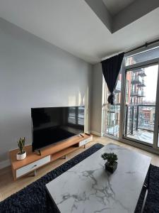 a living room with a large flat screen tv at Vibrant 1 Bedroom Condo Apt in Toronto