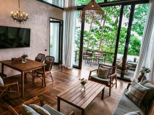 a living room with a table and chairs at The Little Hill Suite in Munduk