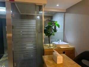 a bathroom with a sink and a glass shower at Orago Stay Hotel in Suwon +106 photos