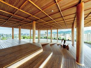 two people sitting on the floor of a building at Vessel Hotel Hiroshima Peace Blvd in Hiroshima