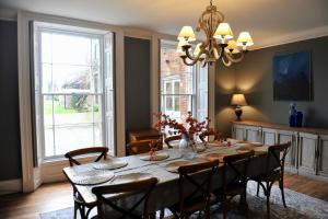 a dining room with a table and chairs at Ash House in Wincanton