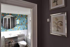 a bathroom with a mirror and a sink and a toilet at Ash House in Wincanton +31 photos
