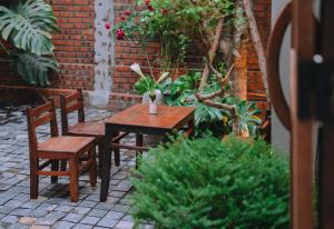 a wooden table and chairs in a garden at Sita Home in Danang