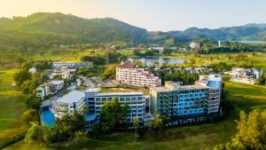 an aerial view of a resort with a lake at The Par Phuket Hotel in Kathu