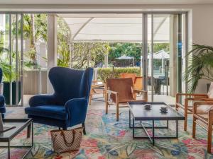 a living room with chairs and a table at Peppers Salt Resort & Spa in Kingscliff