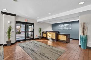 a lobby with a welcome sign on the wall at Hotel SLC in Salt Lake City