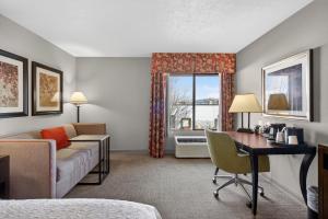 a hotel room with a couch and a desk and a window at Hotel SLC in Salt Lake City +72 photos