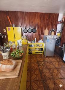 a kitchen with a counter and a refrigerator at Free Spirit Experience Guadalajara Centro in Guadalajara