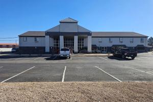 a building with a parking lot in front of it at Super 8 by Wyndham Hobbs in Hobbs