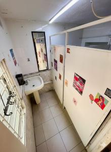 a bathroom with a urinal and a sink in a stall at Free Spirit Experience Guadalajara Centro in Guadalajara +38 photos