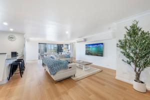 a living room with a couch and a table at Coral Sands 503 in Bargara