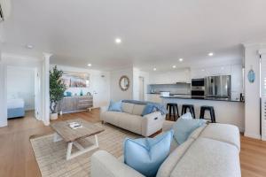 a living room with a couch and a table at Coral Sands 503 in Bargara