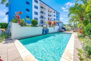 a swimming pool in front of a building at Coral Sands 503 in Bargara