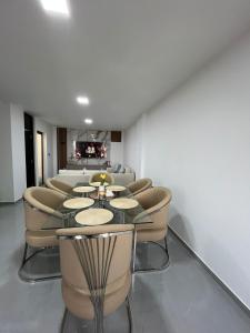 a room with a table and chairs and a couch at Pimentel Casa in Chiclayo