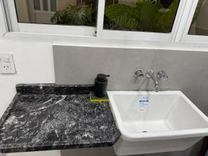 a bathroom with a sink and a window at Temporario J & B in Paso de los Libres