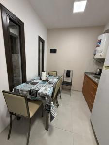 a dining room with a table and chairs in a kitchen at Temporario J & B in Paso de los Libres