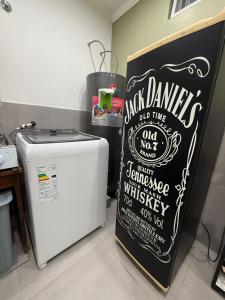 a chalkboard sign next to a refrigerator in a kitchen at Temporario J & B in Paso de los Libres