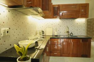a kitchen with wooden cabinets and a sink at Jasmine Homestay in Danang +49 photos