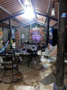 a room with a table and chairs and a mural at La casa de ito in La Chorrera