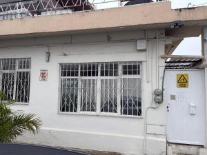 a white building with windows and a door at Departamento Estudio C3 Centrico La Casona in Xalapa