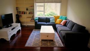 a living room with a couch and a coffee table at Banana Pancakes in Margaret River Town