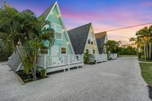 a house with a blue and white house at Anchor Inn & Cottages in Sanibel