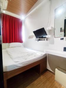 a small room with a bed and a sink at In Inn in Hong Kong
