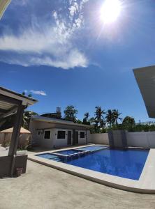 a swimming pool in the backyard of a house at T'zam Villa in Dipolog