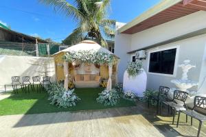 a gazebo with chairs and a table at T'zam Villa in Dipolog