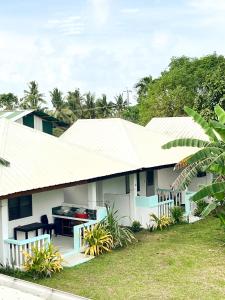 a white house with a white roof at Surfside Bungalows in General Luna