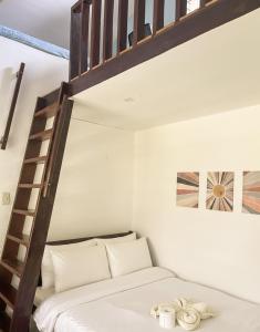 a bedroom with a bunk bed with a ladder at Surfside Bungalows in General Luna