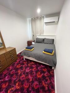 a bedroom with a bed and a red carpet at Stay @ Ray's in West Wyalong