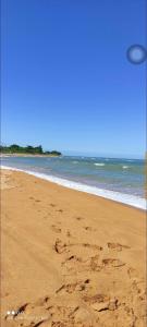 a frisbee is flying over the sand on a beach at Casa temporada Capuba in Serra