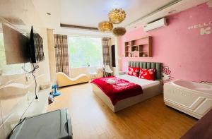 a bedroom with pink walls and a bed and a tub at Duyen Motel in Hanoi +4 photos
