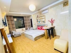 a bedroom with a bed and a desk in it at Duyen Motel in Hanoi