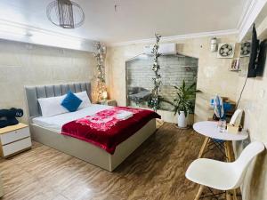 a bedroom with a large bed and a table at Duyen Motel in Hanoi