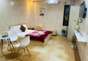a bedroom with a bed and a table and chairs at Duyen Motel in Hanoi