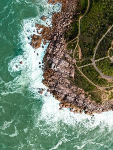 an aerial view of the ocean and a rocky shore at Wren House Victor Harbor in Victor Harbor