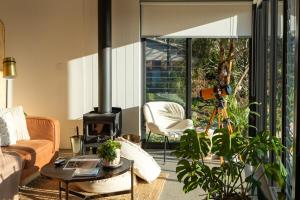a living room with a fireplace and a couch at Wren House Victor Harbor in Victor Harbor
