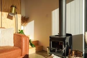 a living room with a fireplace and a couch at Wren House Victor Harbor in Victor Harbor +24 photos