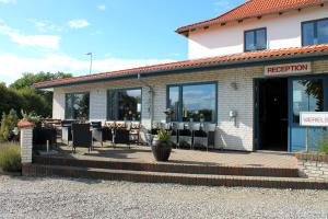 a restaurant with tables and chairs outside of a building at Hotel Medio Fredericia in Fredericia