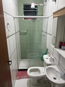 a bathroom with a shower and a toilet and a sink at Casa temporada Capuba in Serra +49 photos