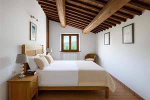 a bedroom with a white bed and a wooden ceiling at VILLA ADELE - Ville Carborello in Crispiero +15 photos