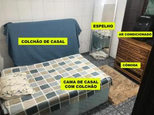 a bed in a room with yellow signs on it at Farofa House Àrea de Lazer in Ribeirão Preto