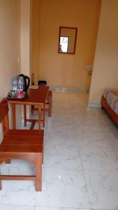 a room with a table and benches and a bed at Tengger Bromo Villa by ABM in Ngadisari