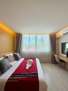 a hotel room with a large bed with a red blanket at MM Hill Koh Samui Hotel - SHA Certified in Chaweng +39 photos