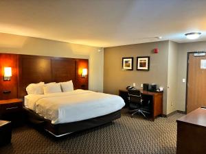 a hotel room with a large bed and a desk at Comfort Inn & Suites Sterling in Sterling +39 photos